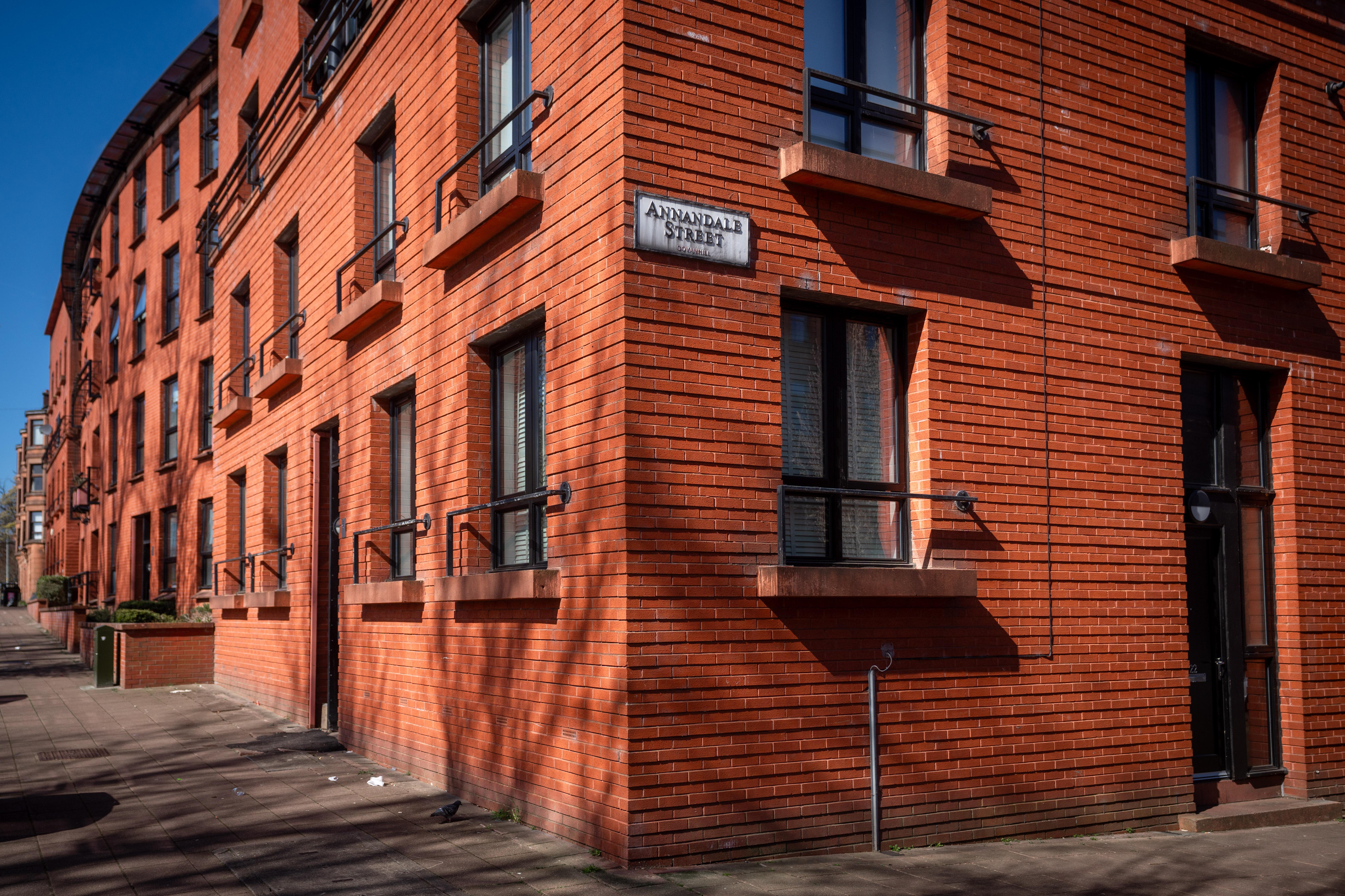 Corner of red-brick flats with street sign